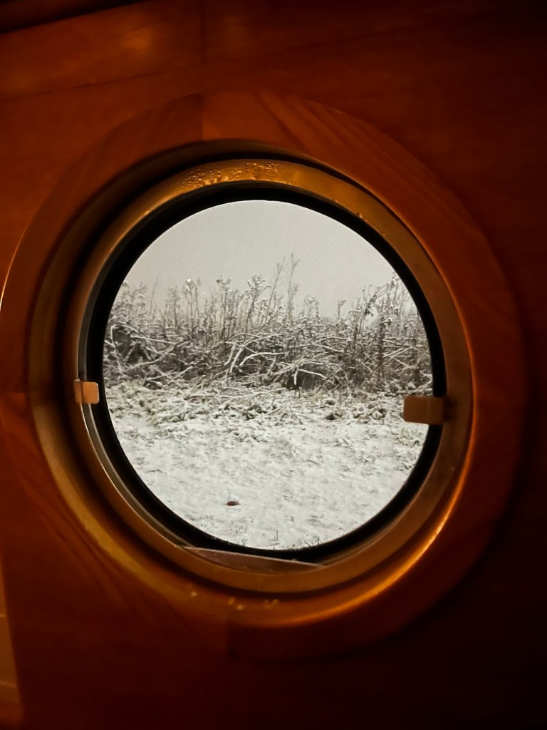 Photo of snow on the tow path through the port hole