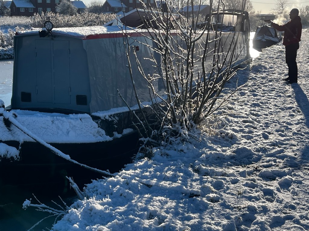 Photo of Narrowboat And Away moored up in the snow and ice